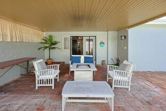 a view of a house with backyard and sitting area