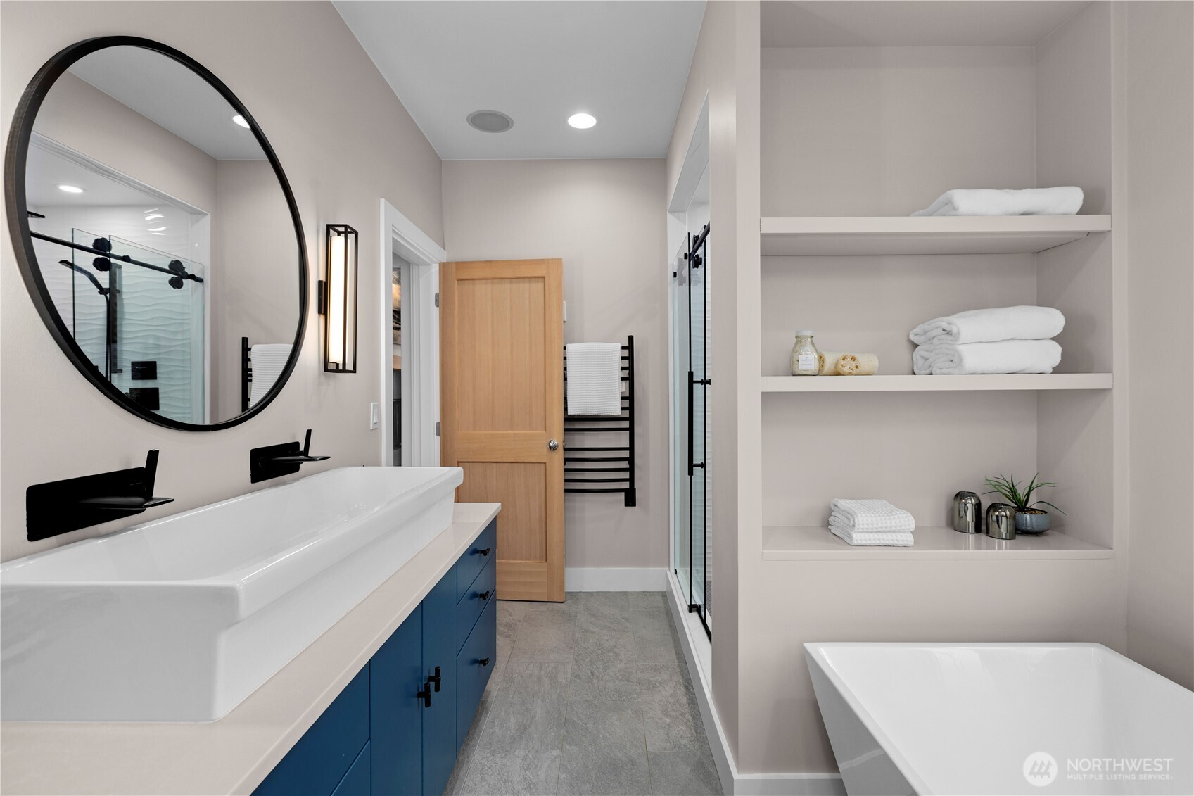 3773 Southwest Grayson Street Seattle, WA 98126 - Photo 33 of 40 a en suite bathroom with a sink a mirror and a bathtub