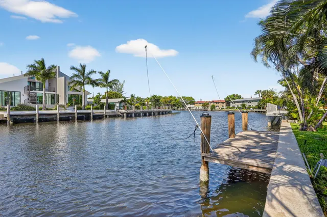 a view of a lake with a table and chairs