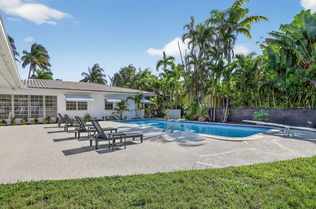 a view of a house with sitting area and a garden