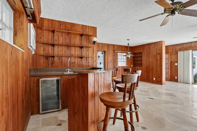 a view of a livingroom with furniture and a ceiling fan
