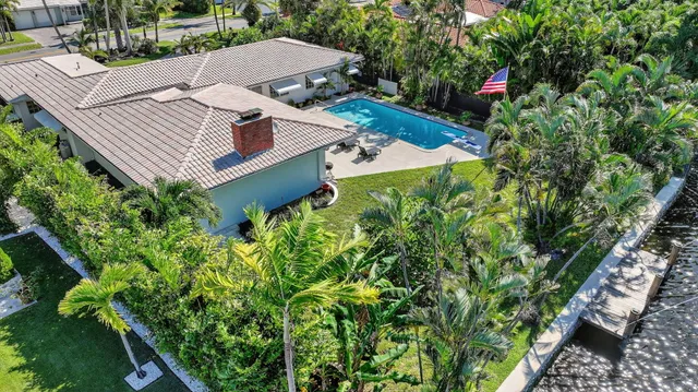 an aerial view of a house with garden space and street view