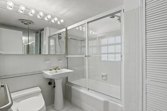 a bathroom with a sink toilet and shower