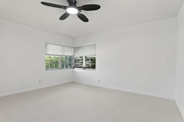 an empty room with a empty space and windows