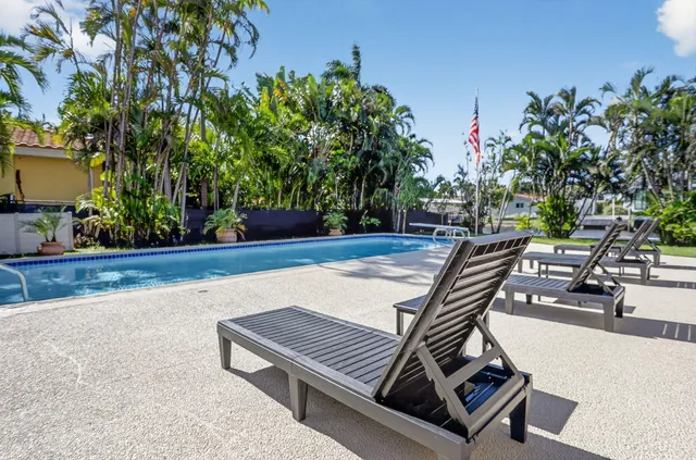 a view of a backyard with sitting area