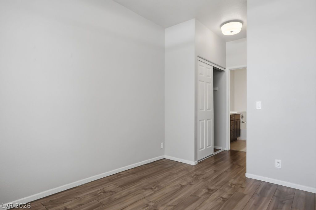 2201 Ramsgate Drive, Unit 514 Henderson, NV 89074 - Photo 16 of 28 A well-lit room features attractive wood flooring and a convenient sliding closet door.