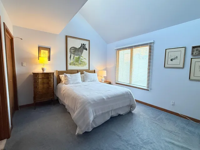 a bedroom with a bed cabinet and window