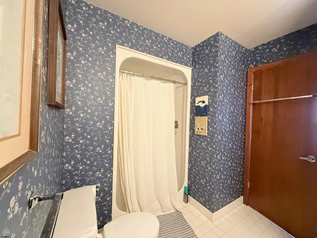 a bathroom with a toilet and shower