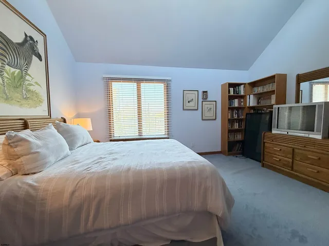 a bedroom with a bed and dresser
