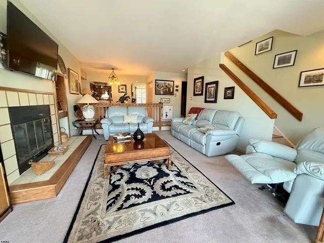 a living room with furniture flat screen tv and a fireplace