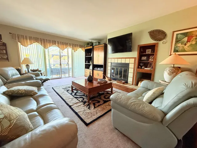 a living room with furniture fireplace and flat screen tv
