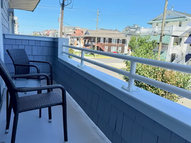 a view of a balcony with an outdoor seating