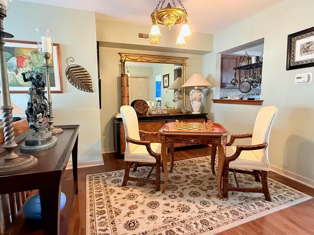 a dining room with furniture and wooden floor