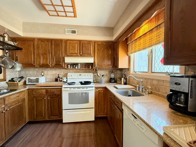 a kitchen with a sink a window and cabinets