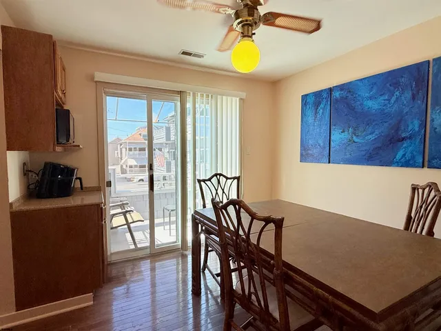 a view of a dining room with furniture and a window