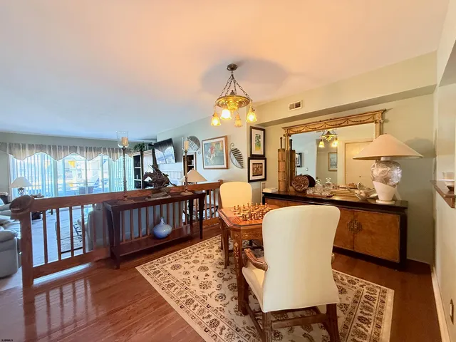 a living room with furniture a fireplace and a large window