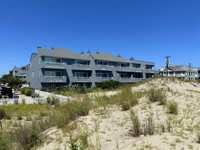 a view of a building with swimming pool and a yard