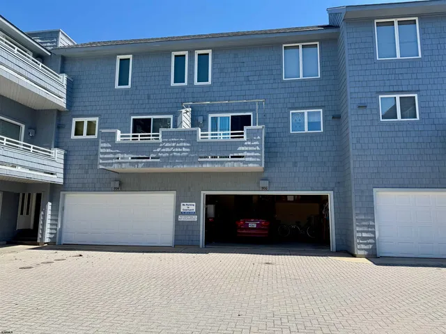 a front view of a building with a couple of windows