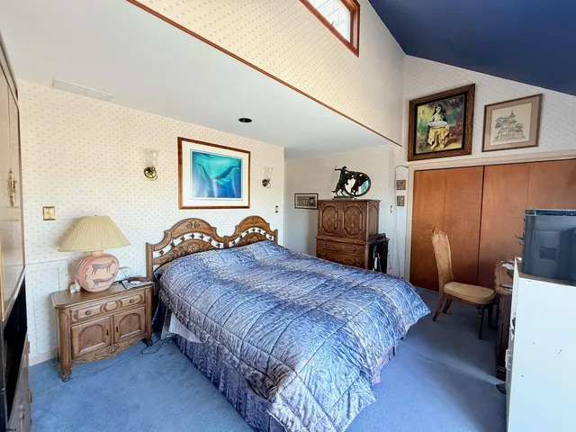 a bedroom with a bed and a furniture