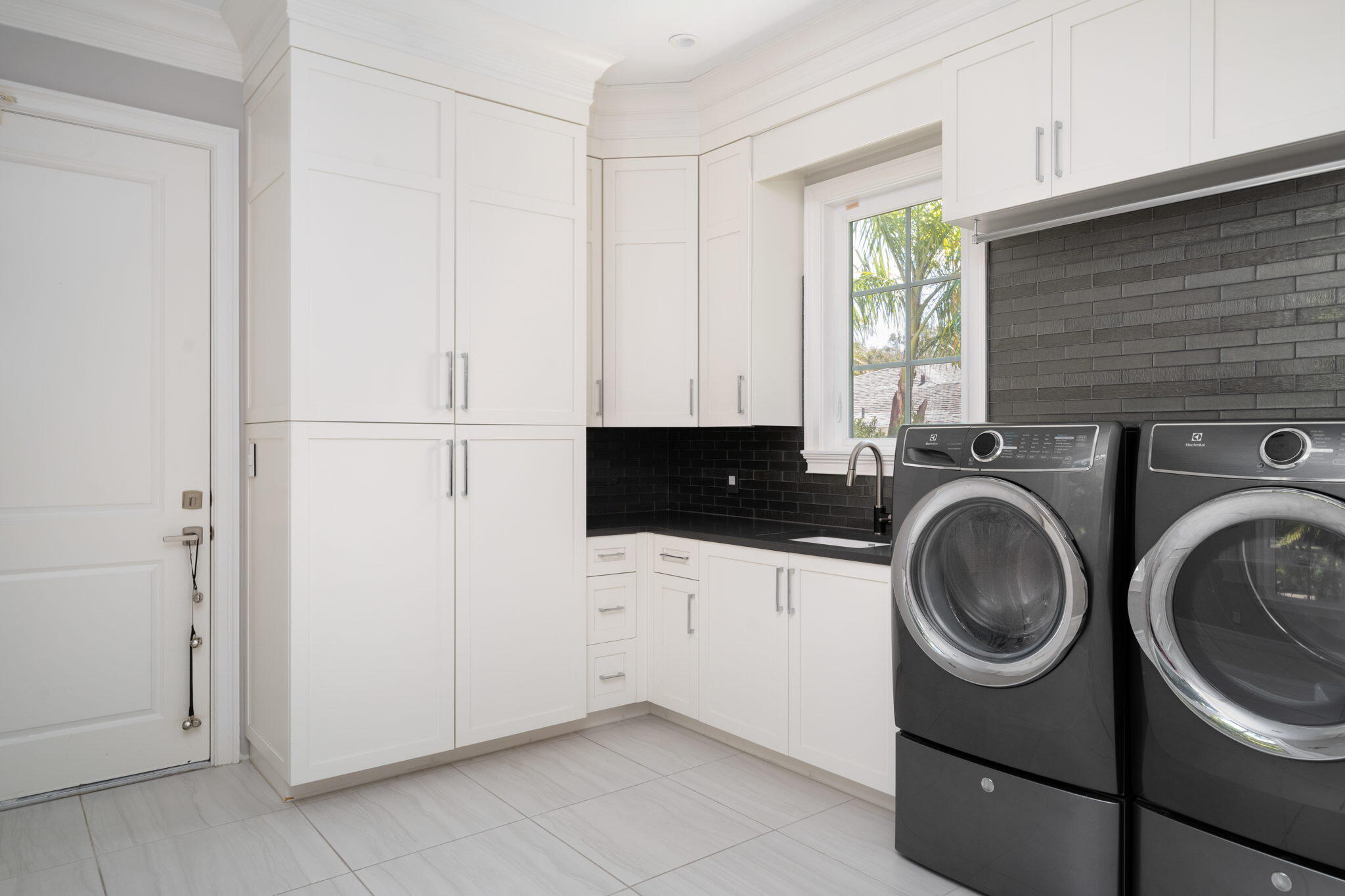 544 Live Oak Road Vero Beach, FL 32963 - Photo 15 of 55 a utility room with sink dryer and washer