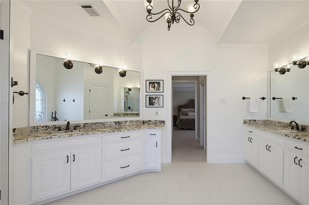 14442 Club Circle Milton, GA 30004 - Photo 37 of 82 a spacious bathroom with a granite countertop sink and a mirror