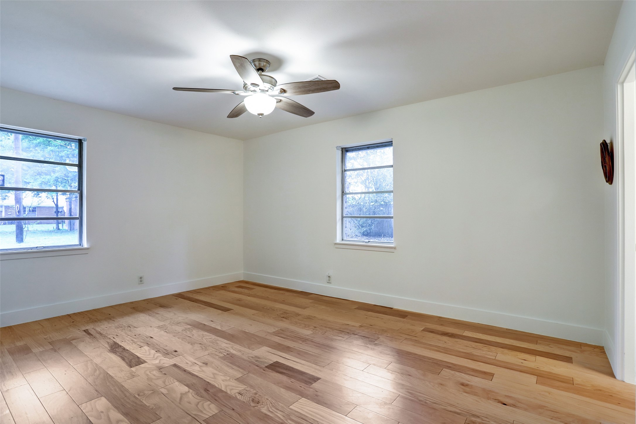 3611 Galway Lane Houston, TX 77080 - Photo 11 of 16 a view of empty room with wooden floor and fan