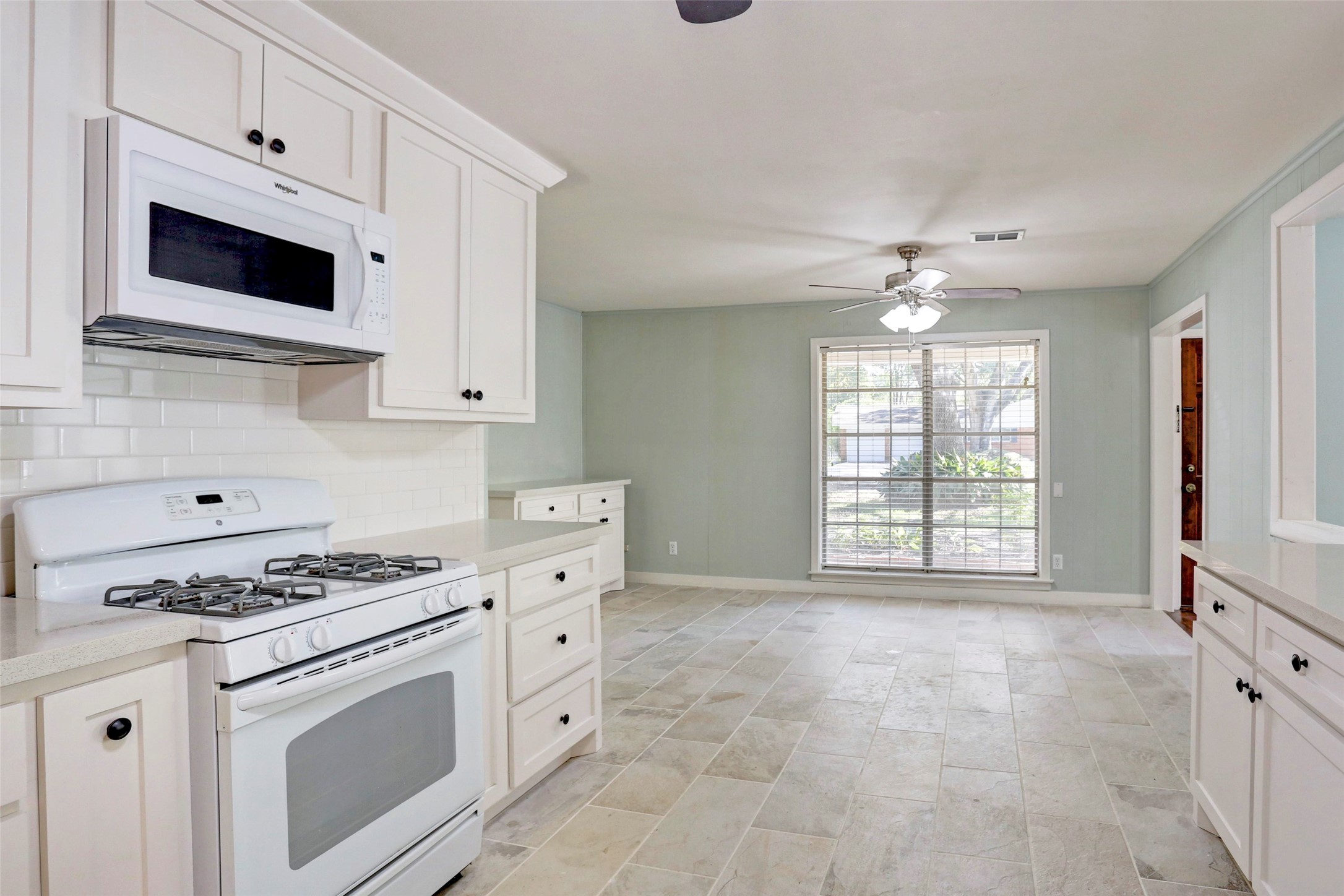 3611 Galway Lane Houston, TX 77080 - Photo 4 of 16 a kitchen with stainless steel appliances white cabinets and a stove