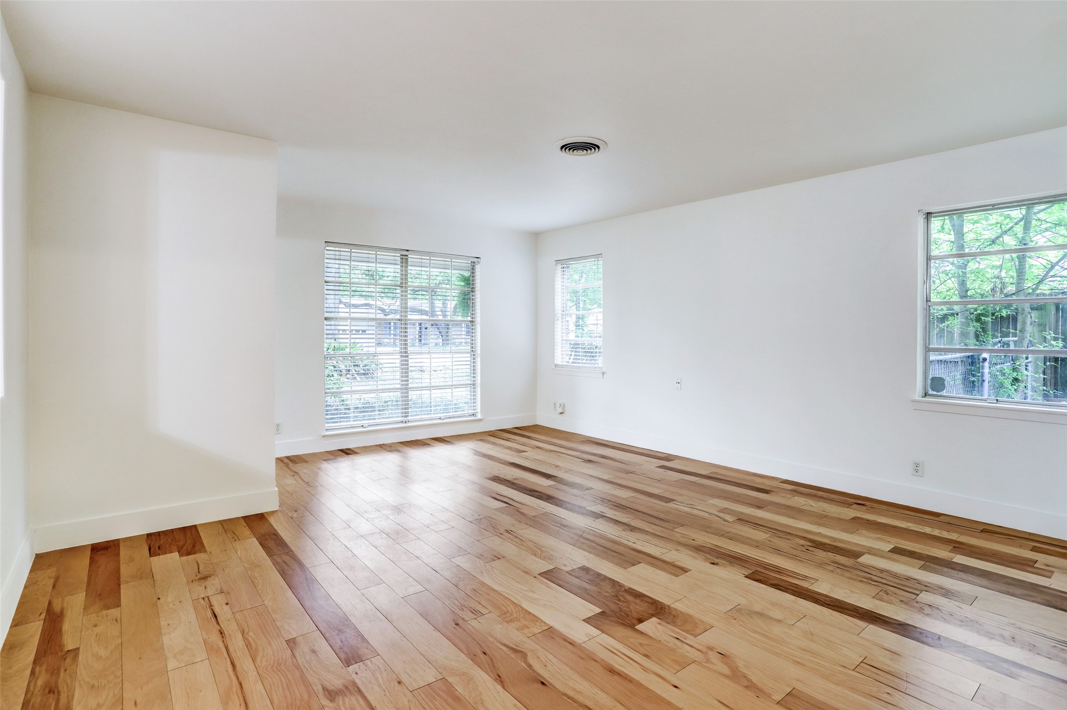 3611 Galway Lane Houston, TX 77080 - Photo 6 of 16 a view of an empty room with wooden floor and a window