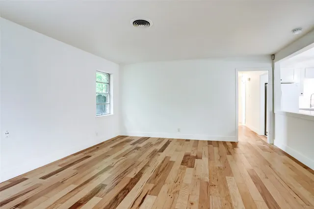 a view of room with window and wooden floor