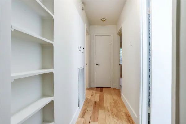 a view of a room with wooden floor