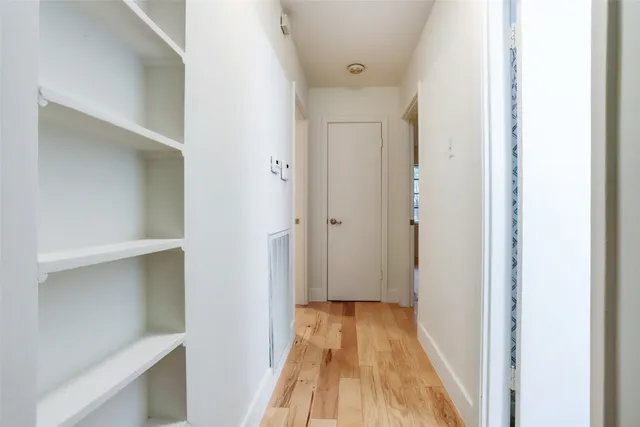 a view of a room with wooden floor