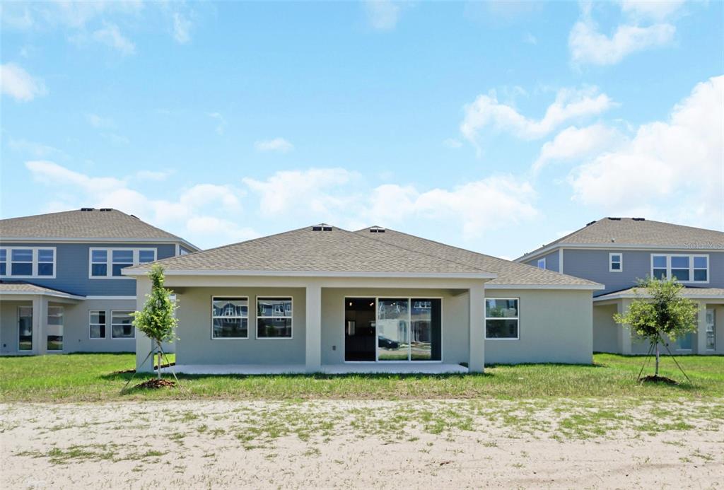 5768 Stephens Road St. Cloud, FL 34771 - Photo 41 of 50 a front view of a house with a garden