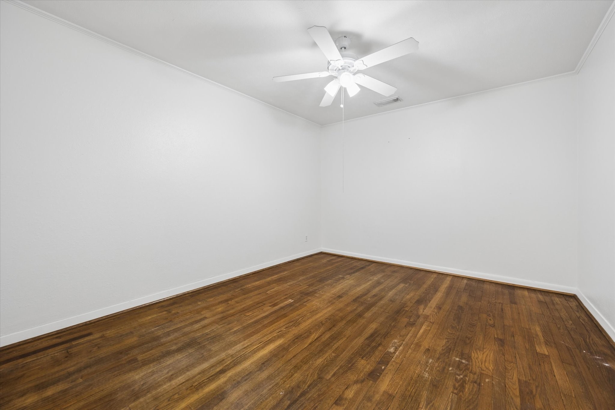 1931 Bissonnet Street Houston, TX 77005 - Photo 16 of 22 an empty room with wooden floor and chandelier fan