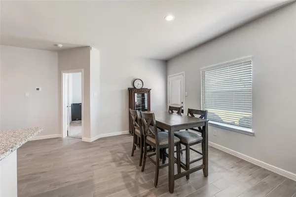 a view of a dining room with furniture and window