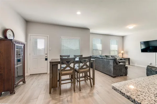 a view of a dining room with furniture and wooden floor