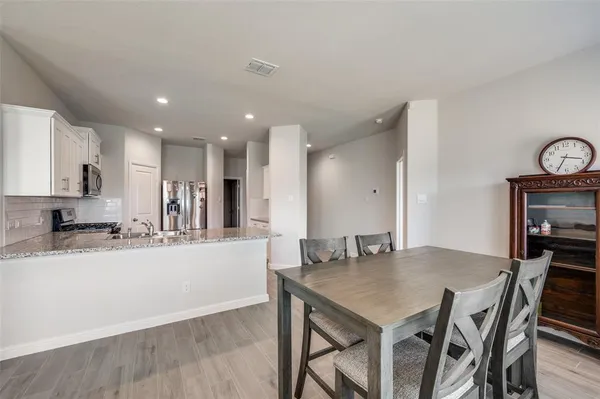 a kitchen with a table and chairs in it