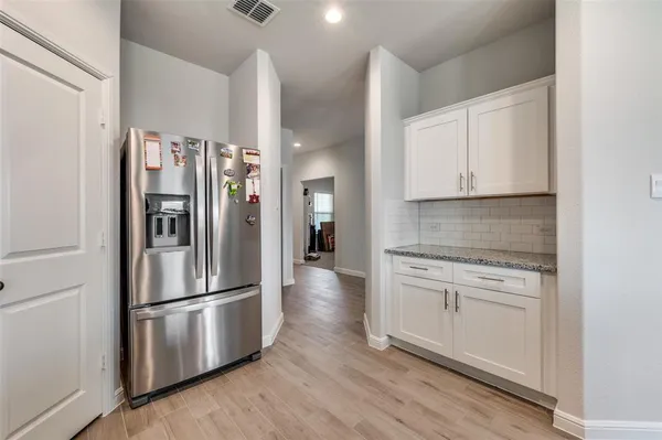 a kitchen with stainless steel appliances a refrigerator sink and cabinets