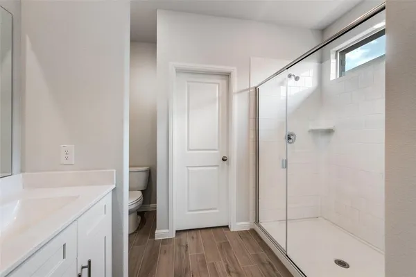 a bathroom with a shower and a sink