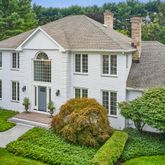a aerial view of a house with yard and green space