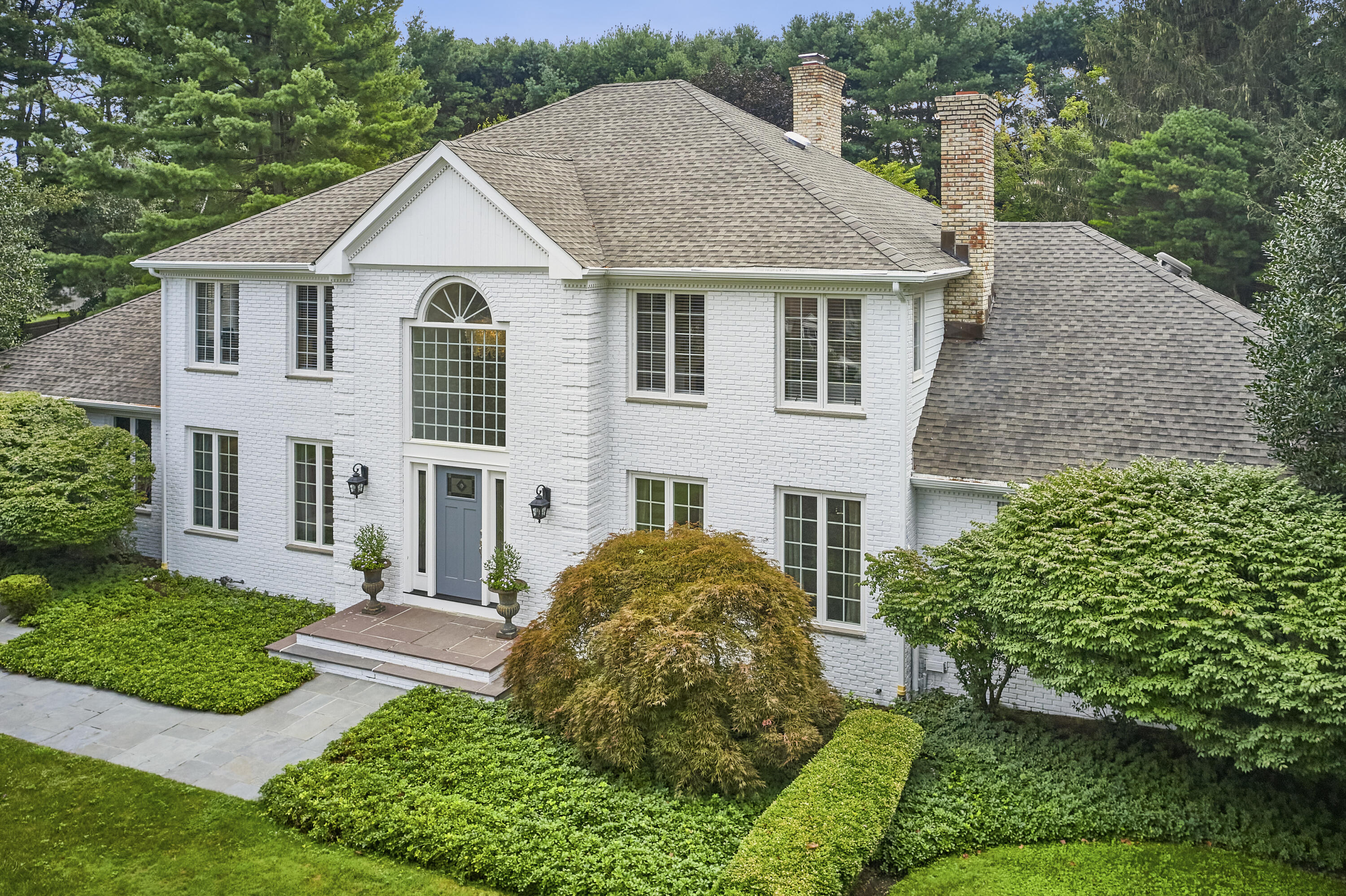 a aerial view of a house with yard and green space
