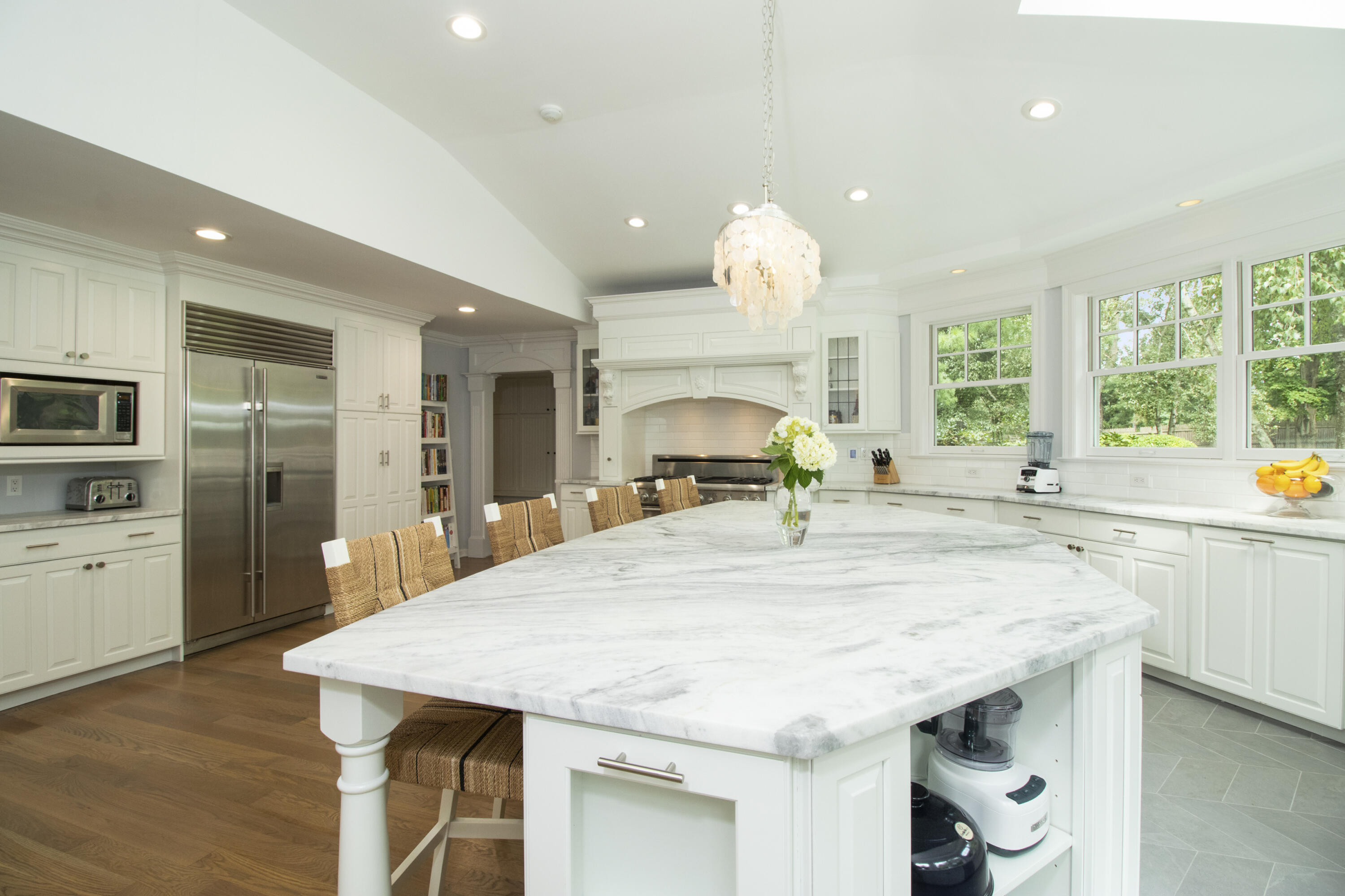 40 Pear Tree Point Road Darien, CT 06820 - Photo 19 of 50 a large kitchen with stainless steel appliances a large kitchen island attached withe living room