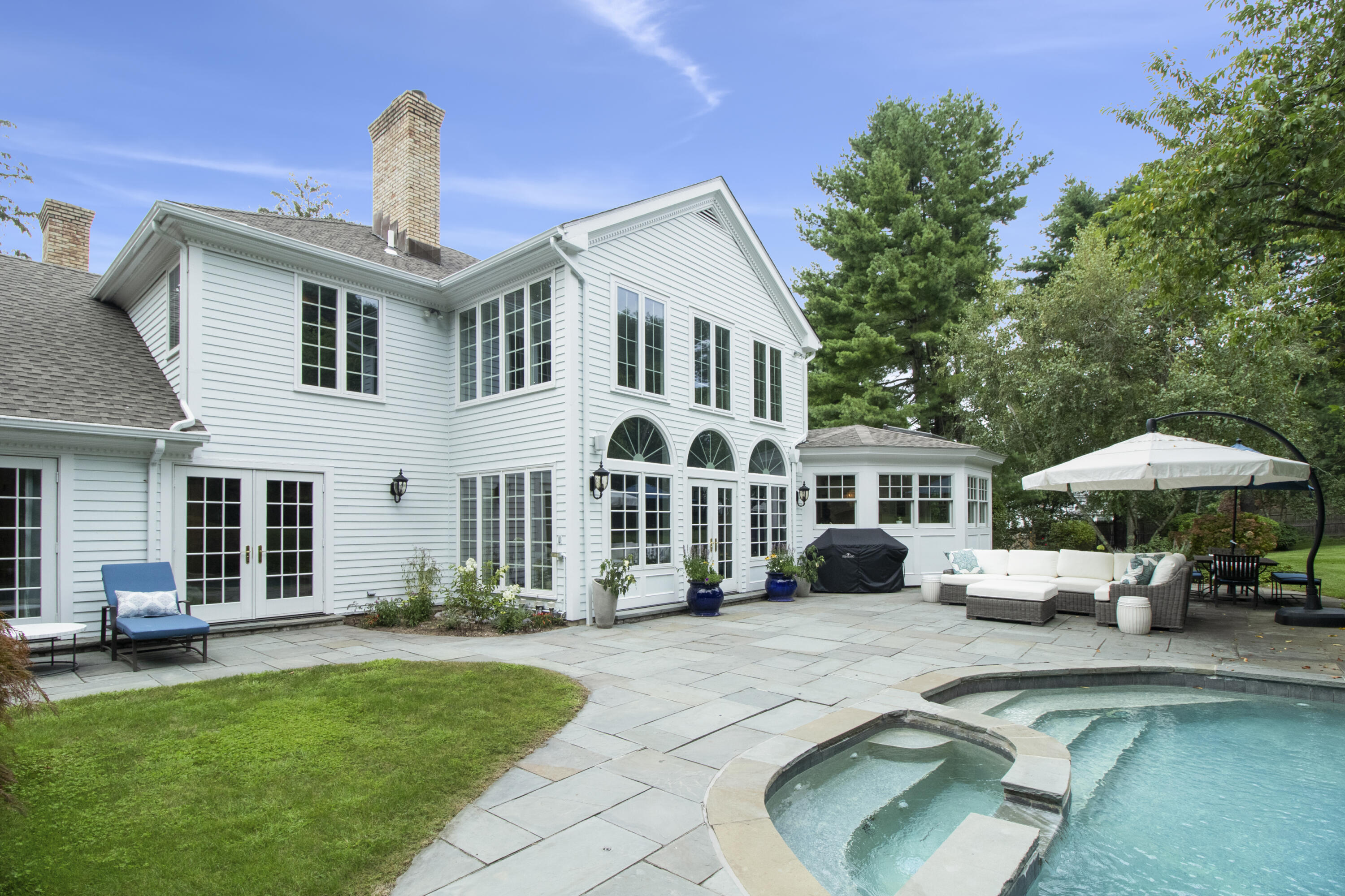 40 Pear Tree Point Road Darien, CT 06820 - Photo 3 of 50 a front view of a house with a yard porch and furniture