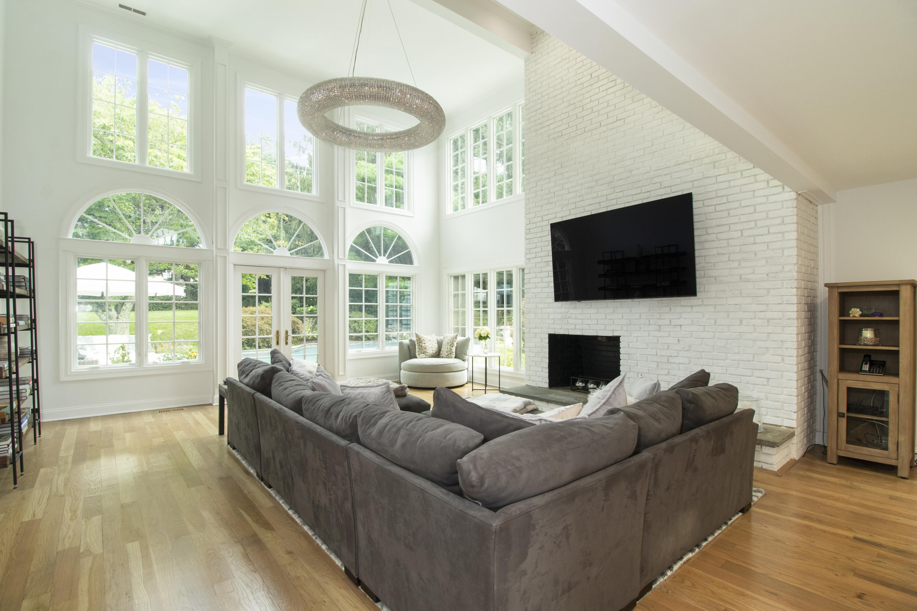 40 Pear Tree Point Road Darien, CT 06820 - Photo 23 of 50 a living room with fireplace furniture and a flat screen tv