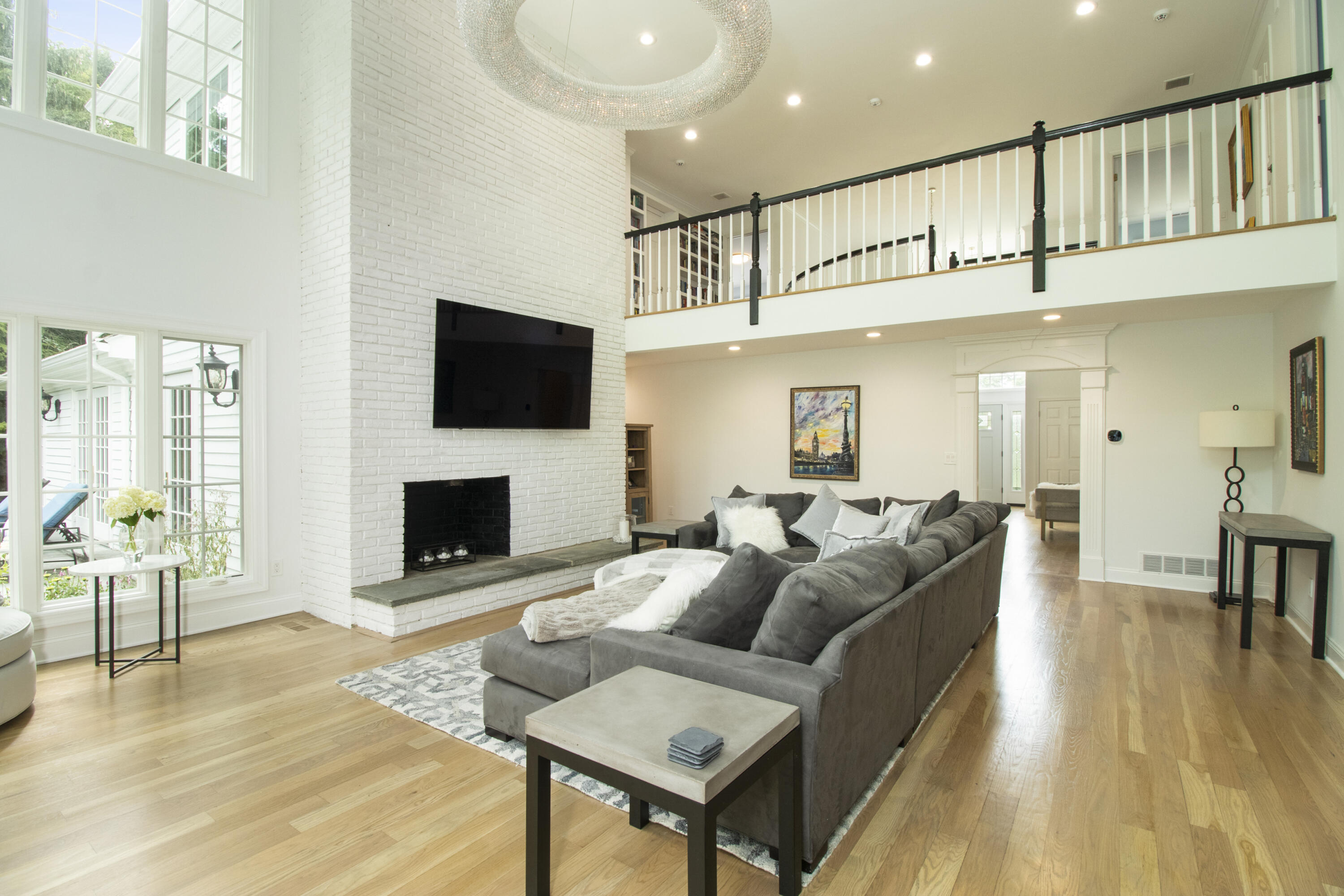 40 Pear Tree Point Road Darien, CT 06820 - Photo 24 of 50 a living room with furniture a flat screen tv and a fireplace