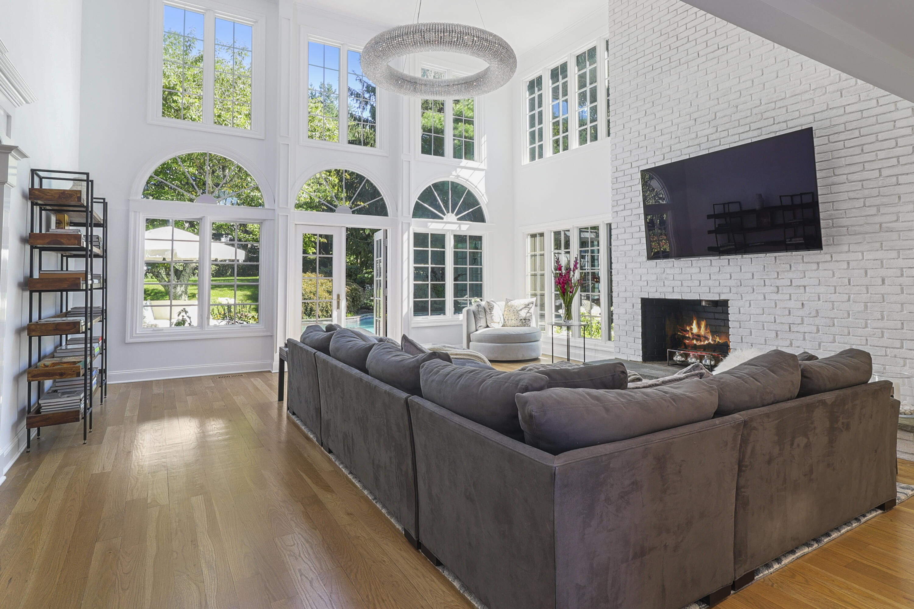 40 Pear Tree Point Road Darien, CT 06820 - Photo 26 of 50 a living room with fireplace furniture and a flat screen tv