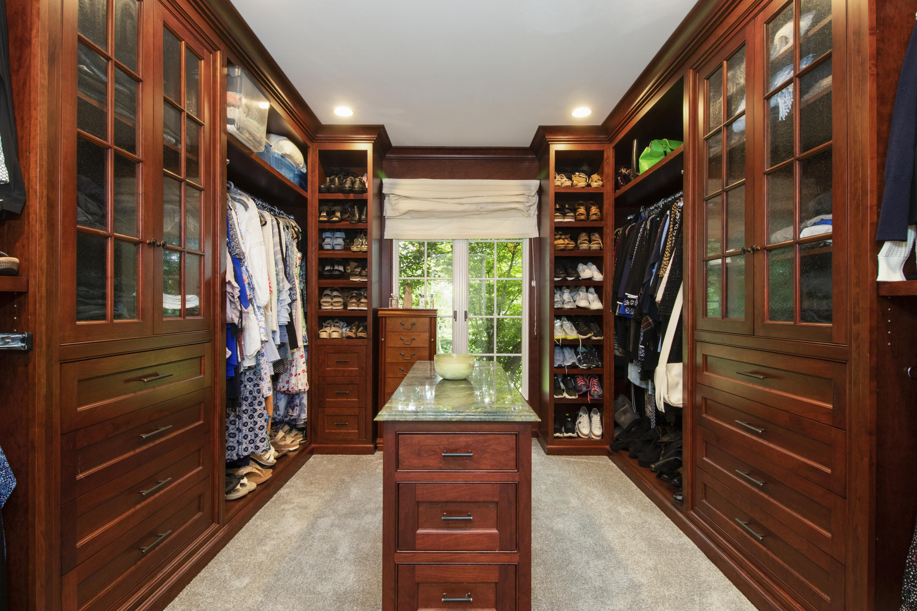 40 Pear Tree Point Road Darien, CT 06820 - Photo 34 of 50 a view of walk in closet with clothes and shoes