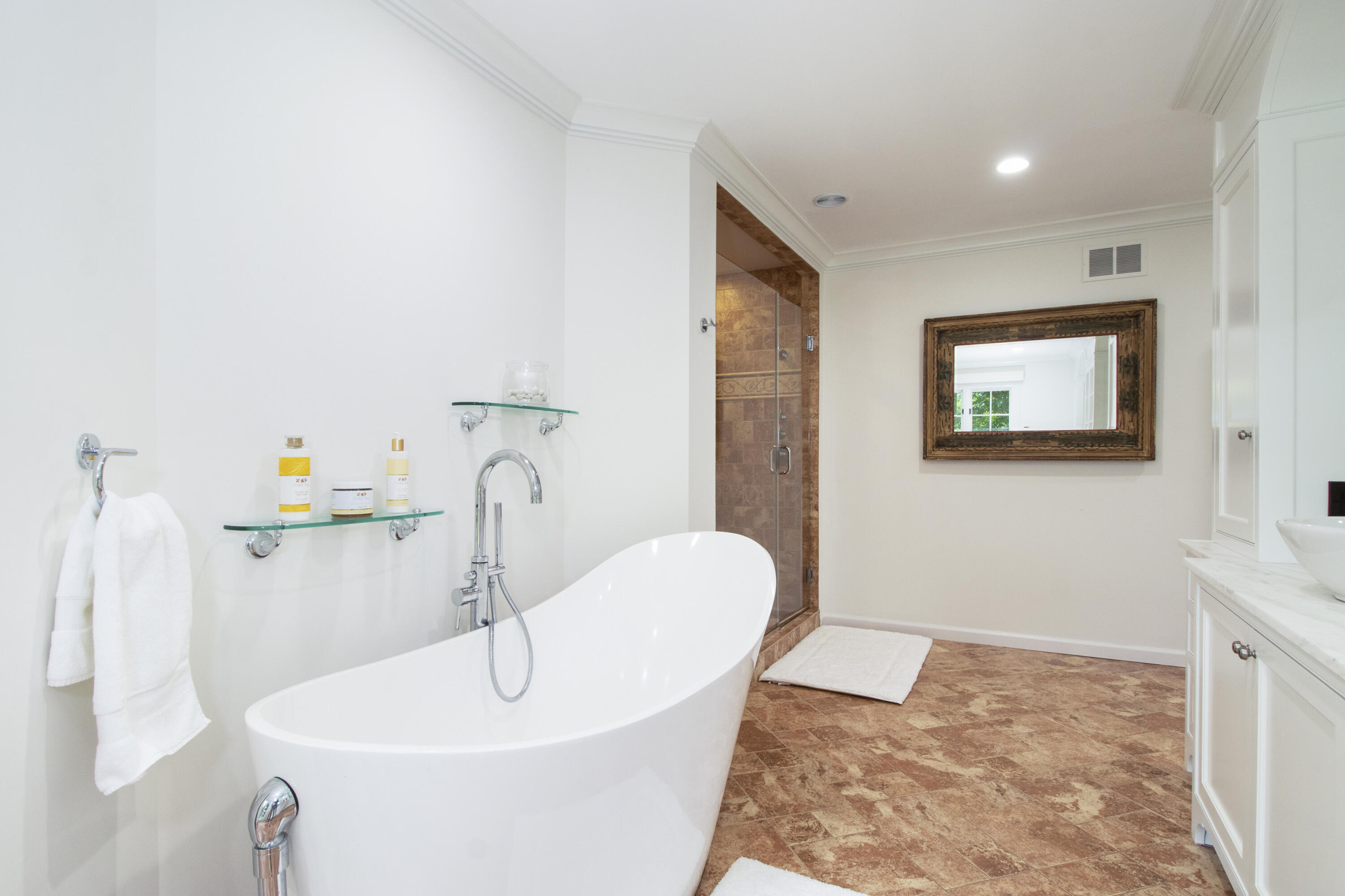 40 Pear Tree Point Road Darien, CT 06820 - Photo 36 of 50 a bathroom with a sink and a mirror