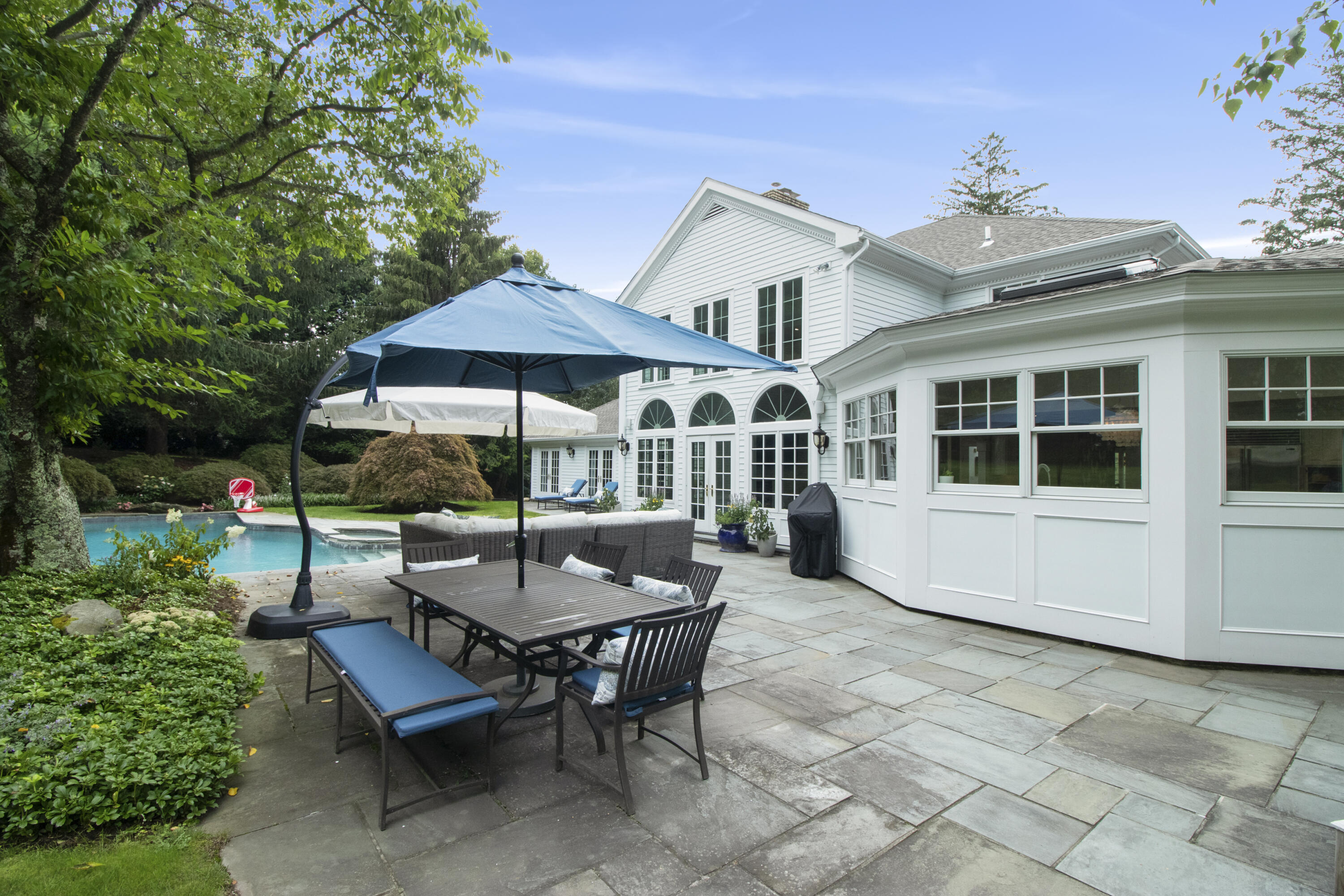 40 Pear Tree Point Road Darien, CT 06820 - Photo 45 of 50 a view of a house with backyard sitting area and garden
