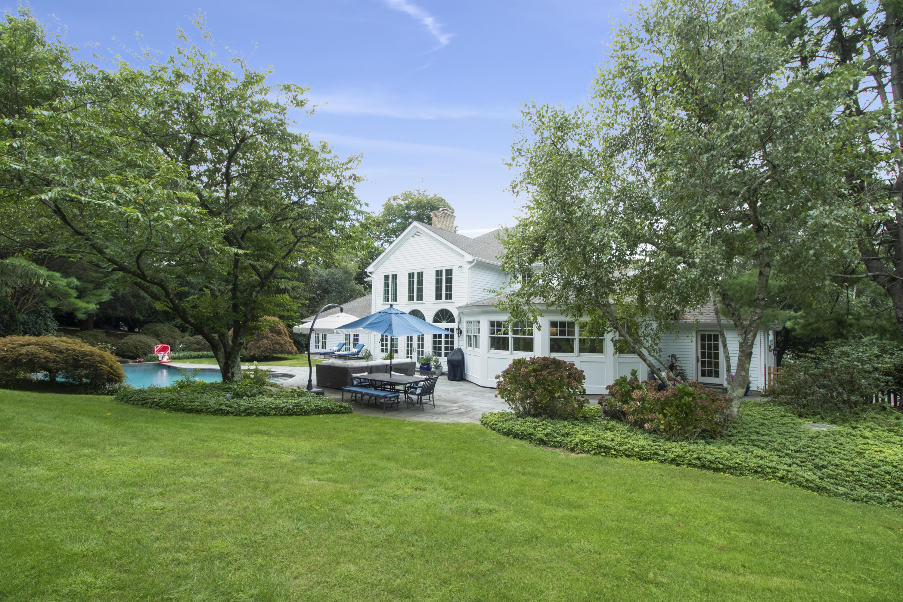 40 Pear Tree Point Road Darien, CT 06820 - Photo 47 of 50 a view of a house with a backyard and sitting area