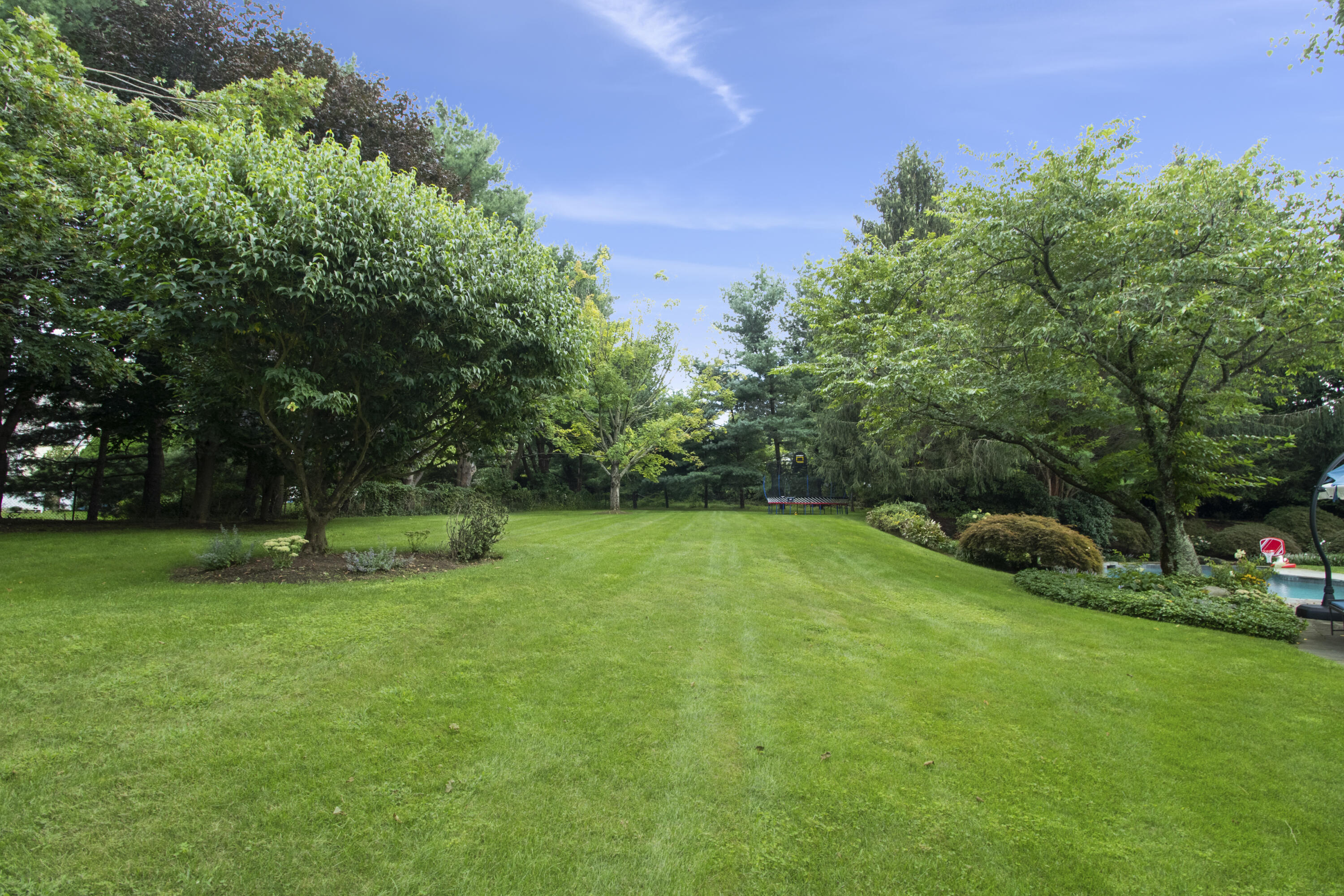 40 Pear Tree Point Road Darien, CT 06820 - Photo 49 of 50 a view of a field of grass and trees